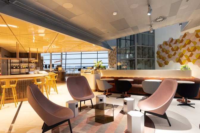 The OP Lounge at Helsinki-Vantaa Airport features a bar with seating and a comfortable lounge area with tables and chairs.