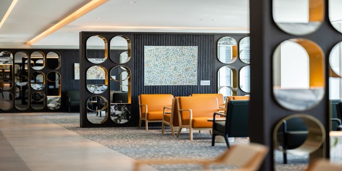 The seating area in Plaza Premium Lounge at Adelaide International Airport features comfortable chairs and a relaxing environment.