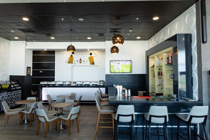 The Adinkra Lounge at Kotoka International Airport features a bar with seating and a buffet area for self-serve dining.