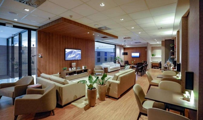 The Break Travel Lounge at Afonso Pena International Airport features comfortable seating areas with sofas, armchairs, and tables for relaxation.
