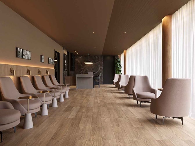The W Premium Lounge in Curitiba features a seating area with individual chairs and side tables, offering a comfortable waiting space.