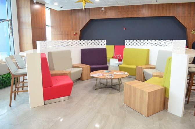 The seating area at Akwaaba Lounge, Kotoka International Airport, features varied seating options with tables for reading materials and relaxation.