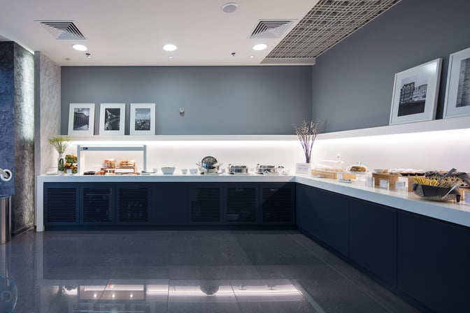 The Goldair Handling CIP Lounge at Athens International Airport features a self-serve food area with various snacks and beverages.
