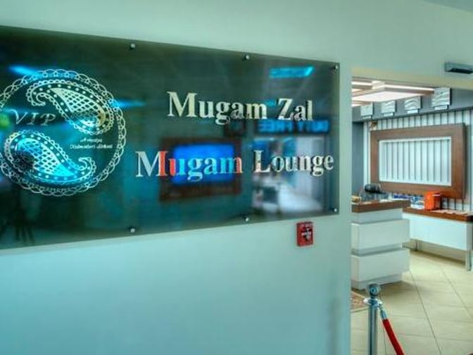 The entrance to Mugam Lounge at Heydar Aliyev International Airport features a sign and leads into a reception area.