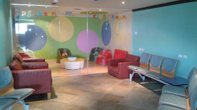 The children's area in the Airlines Executive Lounge at Grantley Adams International Airport features colorful seating and a play space.