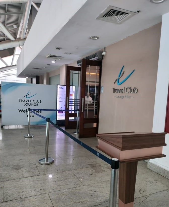 The entrance to the Travel Club Lounge at Chennai International Airport features a welcome sign and a reception podium.