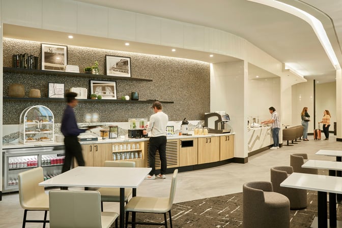 Self-serve beverage and snack station at The Club MDW offers a variety of drinks and light refreshments for travelers.