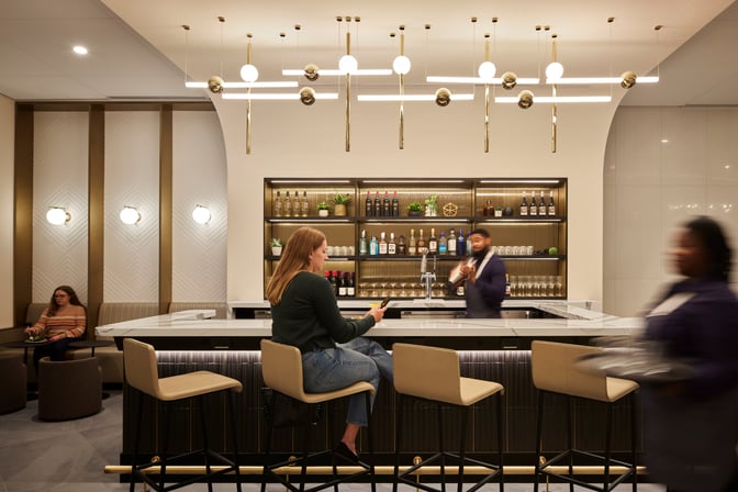 The Club MDW bar at Chicago Midway International Airport offers a variety of spirits with counter seating available for guests.