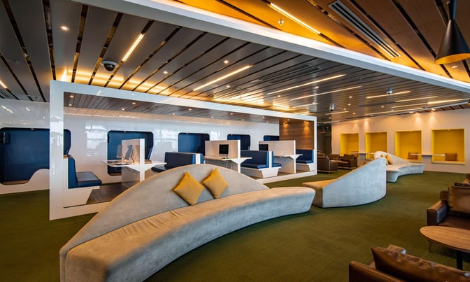 The CIP Orchid Lounge at Da Nang International Airport features booth seating with workstations and comfortable lounge chairs for relaxation.