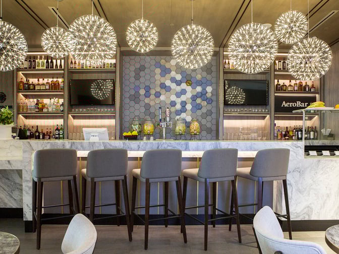 The Plaza Premium Lounge at Dallas-Fort Worth International Airport features a bar with a selection of spirits.