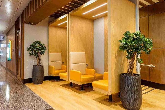 Private seating pods at Doha Hamad International Airport's Sleepover North Node lounge offer individual chairs with high backs and armrests for comfort.