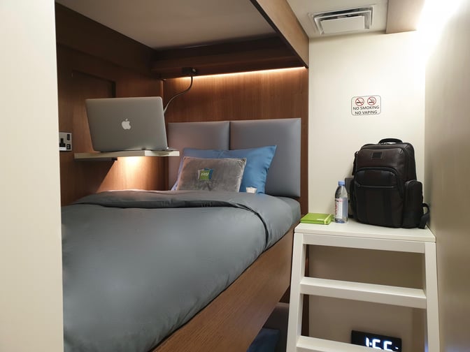 The sleep 'n fly YAWN Bunk Cabin at Doha Hamad International Airport features a compact sleeping area with a bed, shelf, and storage space.