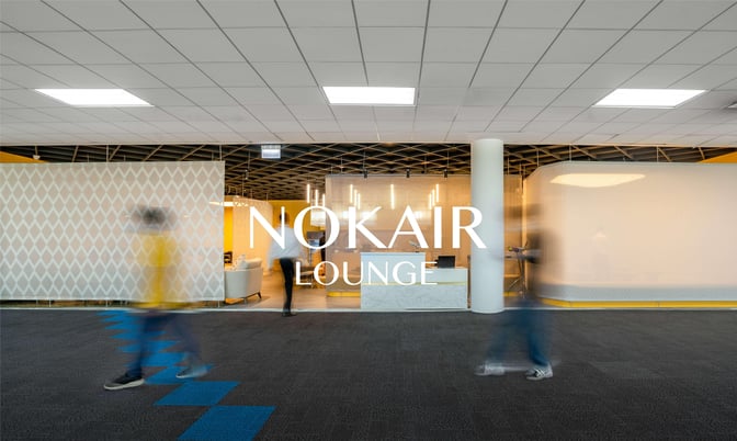 The Nok Air Lounge entrance at Don Mueang International Airport features a reception desk and visible seating area inside.