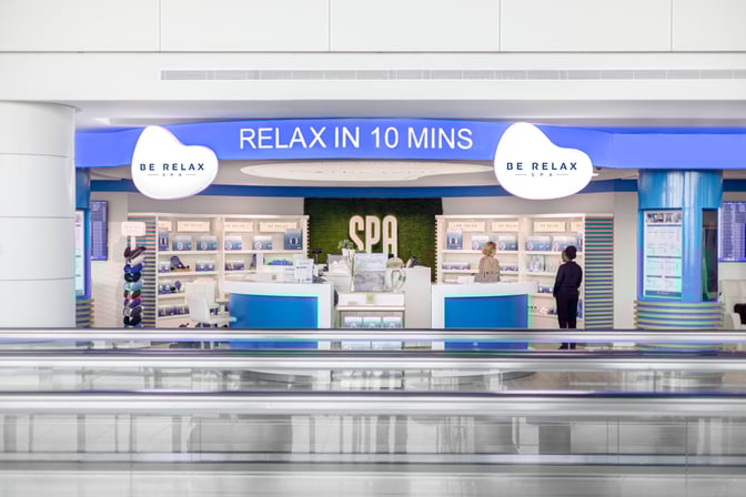 The Be Relax Spa at Dubai International Airport offers quick relaxation services with a visible reception and product display area.