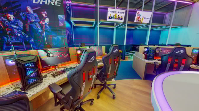 The Game Space at Dubai International Airport features gaming stations with high-end PCs, ergonomic chairs, and large monitors for travelers.