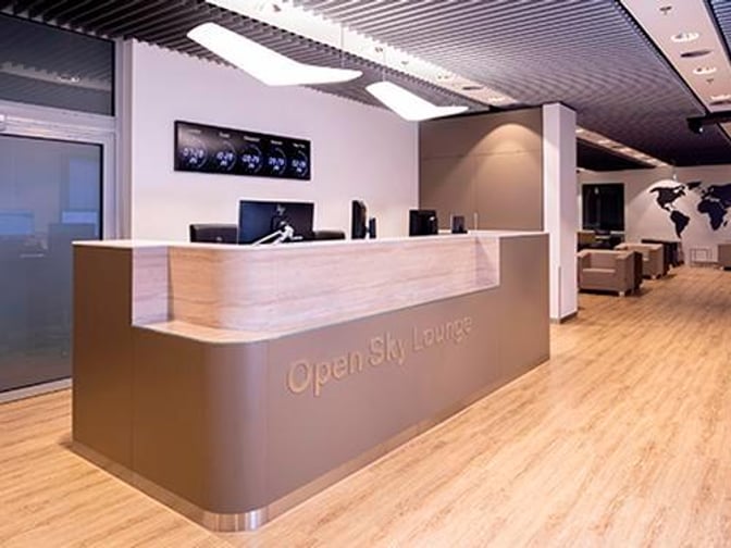 The Open Sky Lounge entrance at Dusseldorf Airport features a reception desk with seating areas visible in the background.