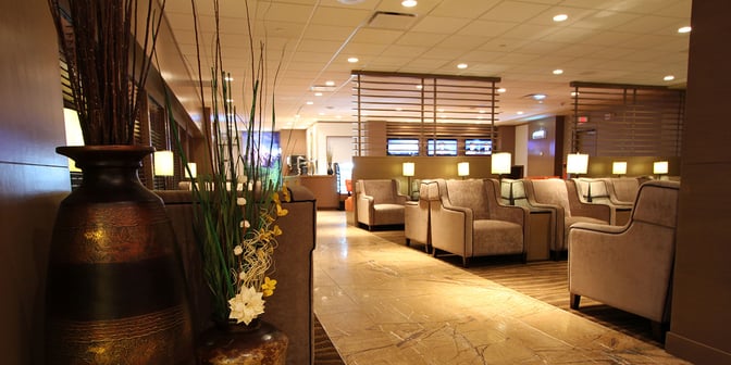 The seating area in Plaza Premium Lounge at Edmonton International Airport features comfortable armchairs and partitioned sections for privacy.