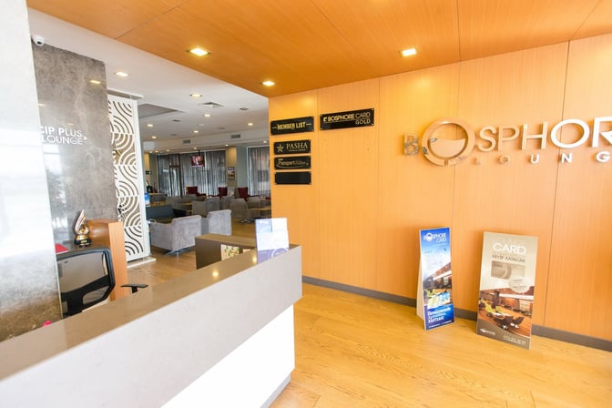The entrance to the Bosphore CIP Lounge at Ercan International Airport features a reception desk and seating area visible inside.