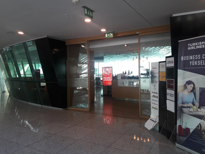 The entrance to the Primeclass Lounge at Esenboğa International Airport features glass doors and signage for business class services.
