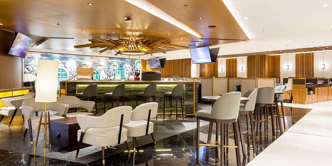The Plaza Premium Lounge at Rio de Janeiro–Galeão International Airport features a bar area with high stools and surrounding seating.
