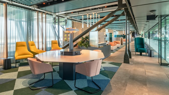 The Crystal Lounge at Geneva International Airport features a seating area with various chairs and tables, offering a comfortable waiting space.