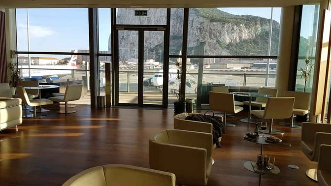 The Calpe Lounge at Gibraltar International Airport features seating with views of the runway and the iconic Rock of Gibraltar.