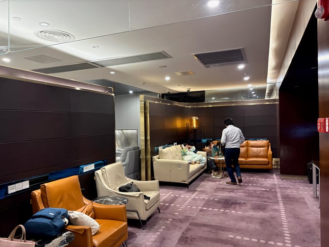 Seating area in the China Southern Skypearl Lounge at Guangzhou Baiyun Airport features comfortable chairs and sofas with accessible power outlets.