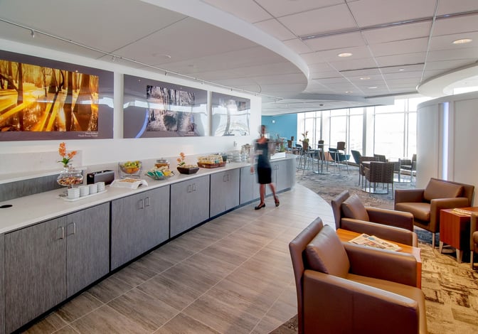 The Club ATL lounge at Hartsfield–Jackson features a self-serve snack area with seating and views of the airport.