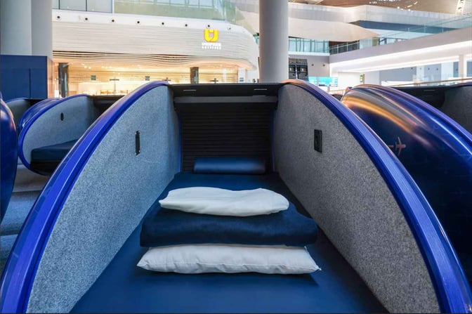 The iGA Sleepod at Istanbul Airport offers individual sleeping pods with pillows and blankets for travelers needing rest.