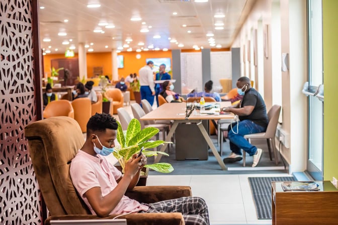 The seating area at Twiga Lounge features comfortable chairs and tables, providing a space for relaxation and device charging.