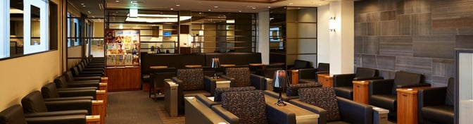 The Card Members Lounge Rokko at Kansai International Airport features comfortable seating with individual tables and a magazine rack for guests.