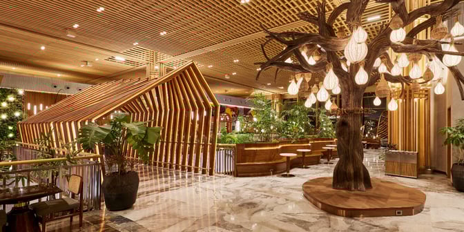 The 080 Domestic Lounge at Kempegowda Bangalore International Airport features a seating area with tables, chairs, and decorative lighting.