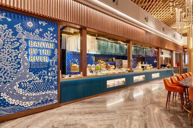 The food area in the 080 International Lounge at Kempegowda Airport offers a variety of self-serve options and seating.