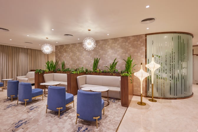 The seating area in the 080 VIP Arrivals Lounge at Kempegowda Bangalore International Airport features comfortable chairs and tables with privacy partitions.