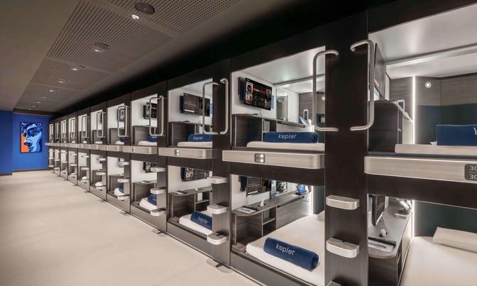 The Kepler Club at Kuala Lumpur International Airport features individual sleeping pods equipped with bedding, personal screens, and storage space.