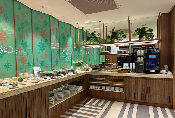 Self-serve food and beverage station in the Travel Club Lounge at Kuala Lumpur International Airport offers a variety of dishes and drinks.