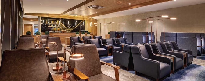 The Plaza Premium Lounge at Mactan-Cebu International Airport features comfortable seating and a bar area with various beverages.