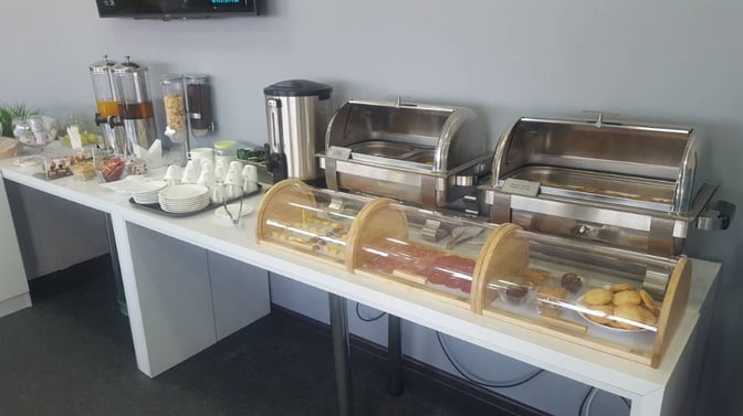 The self-serve food area at Manas International Airport's Business Lounge offers a variety of pastries, cereals, and beverages.