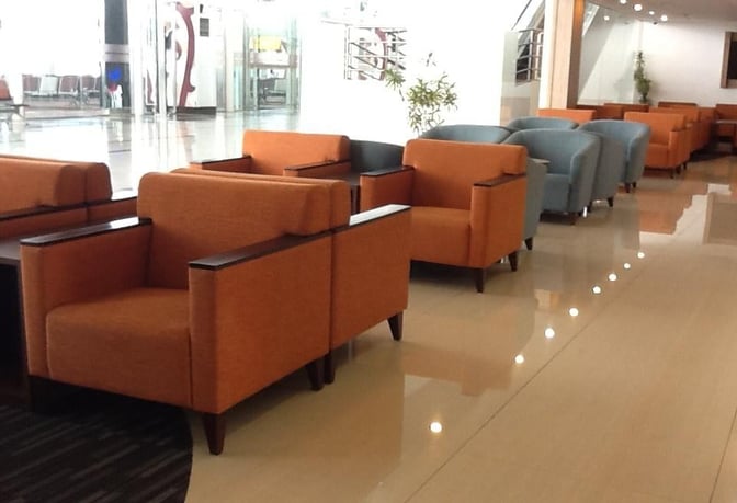 Seating area in the Saphire Lounge at Kualanamu International Airport features rows of armchairs for passenger comfort and relaxation.