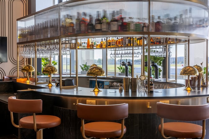 The bar at Aspire Lounge in Montreal-Trudeau Airport offers a selection of spirits and wines with counter seating available.
