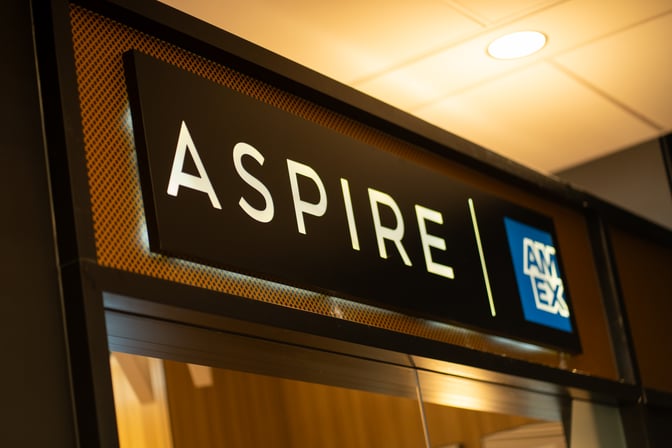 The entrance to the Aspire Lounge at Montreal-Trudeau International Airport features prominent signage above the doorway.