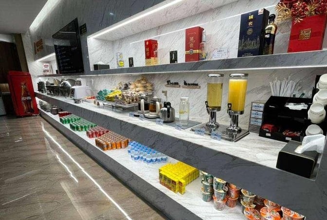 The self-serve food and beverage area in China Southern Airlines Lounge at Nanjing Lukou Airport offers snacks, drinks, and condiments.