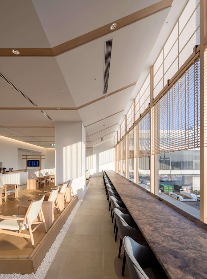 The IASS Superior Lounge at Narita International Airport features a long counter with seating and a view of the tarmac.