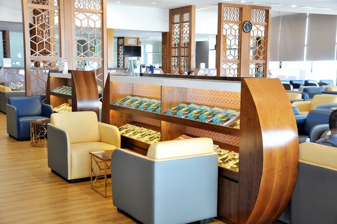 The Vietnam Airlines Lotus Lounge at Noi Bai International Airport features comfortable seating and a magazine rack for passenger convenience.