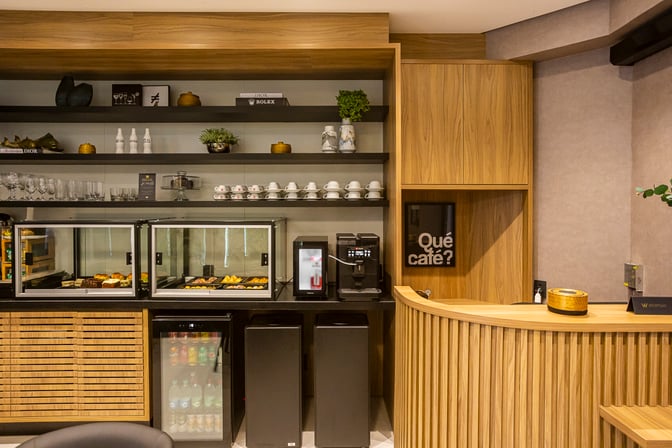 The W Café Lounge at Brigadeiro Lysias Rodrigues Airport features a self-serve area with pastries, a coffee machine, and beverage options.