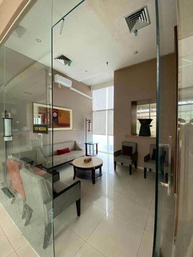 The VIP room at Saphire Lounge, Depati Amir Airport, features comfortable seating with a sofa and chairs around a central table.