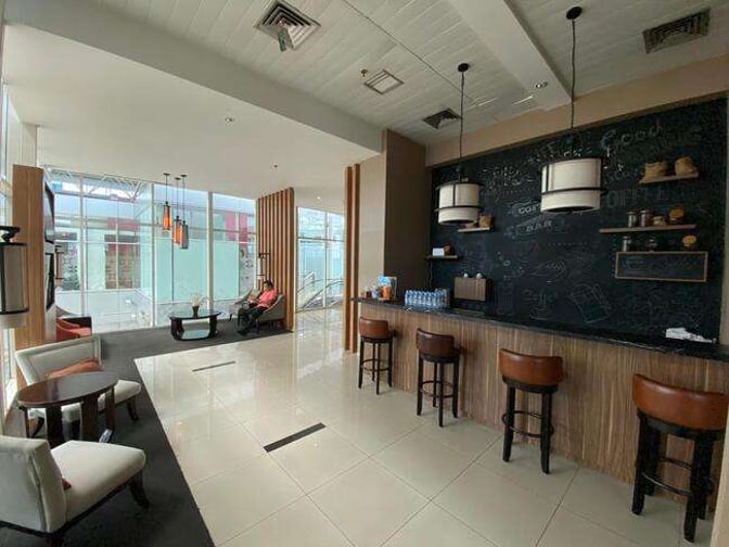 The Saphire Lounge at Depati Amir Airport features a bar area with counter seating and a seating area with tables and chairs.