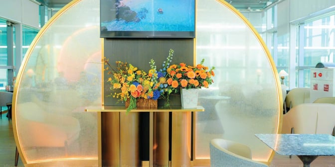 The SENS Leisure Lounge at Phu Quoc International Airport features a decorative floral display with seating areas visible in the background.