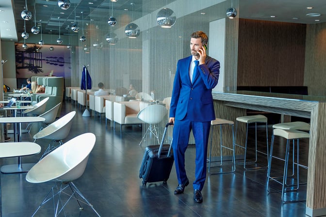 The Erste Premier Lounge at Prague Airport features a seating area with tables and chairs, and a bar with high stools.