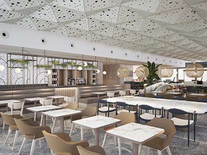 The Plaza Premium Lounge at Sabiha Gokcen International Airport features a spacious seating area with tables and chairs for dining and relaxation.
